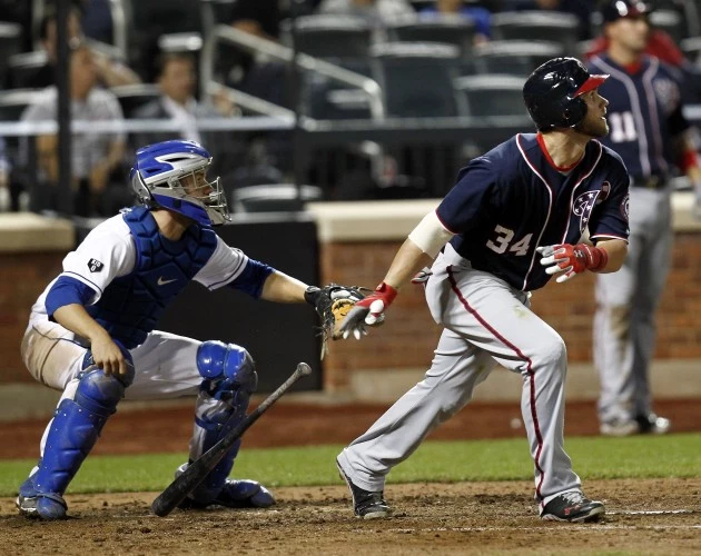 NEW YORK - SEPTEMBER 11: Bryce Harper #34 of the Washington Nationals hits an RBI single in front of Josh Thole #30 of the New York Mets during a game at Citi Field on September 11, 2012 in the Flushing neighborhood of the Queens borough of New York City. (Photo by Jeff Zelevansky/Getty Images) NEW YORK - SEPTEMBER 11: Bryce Harper #34 of the Washington Nationals hits an RBI single in front of Josh Thole #30 of the New York Mets during a game at Citi Field on September 11, 2012 in the Flushing neighborhood of the Queens borough of New York City. (Photo by Jeff Zelevansky/Getty Images)