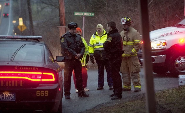 FRANKSTOWN TWP, PA - DECEMBER 21: Blair County Sheriffs Deputies stand at the road block in Blair County on December 21, 2012 in Frankstown Township, Pennsylvania. According to reports, a man shot and killed two men and one woman and injured three state troopers before being shot and killed by police along Juniata Valley Road in Frankstown Township. (Jeff Swensen/Getty Images)